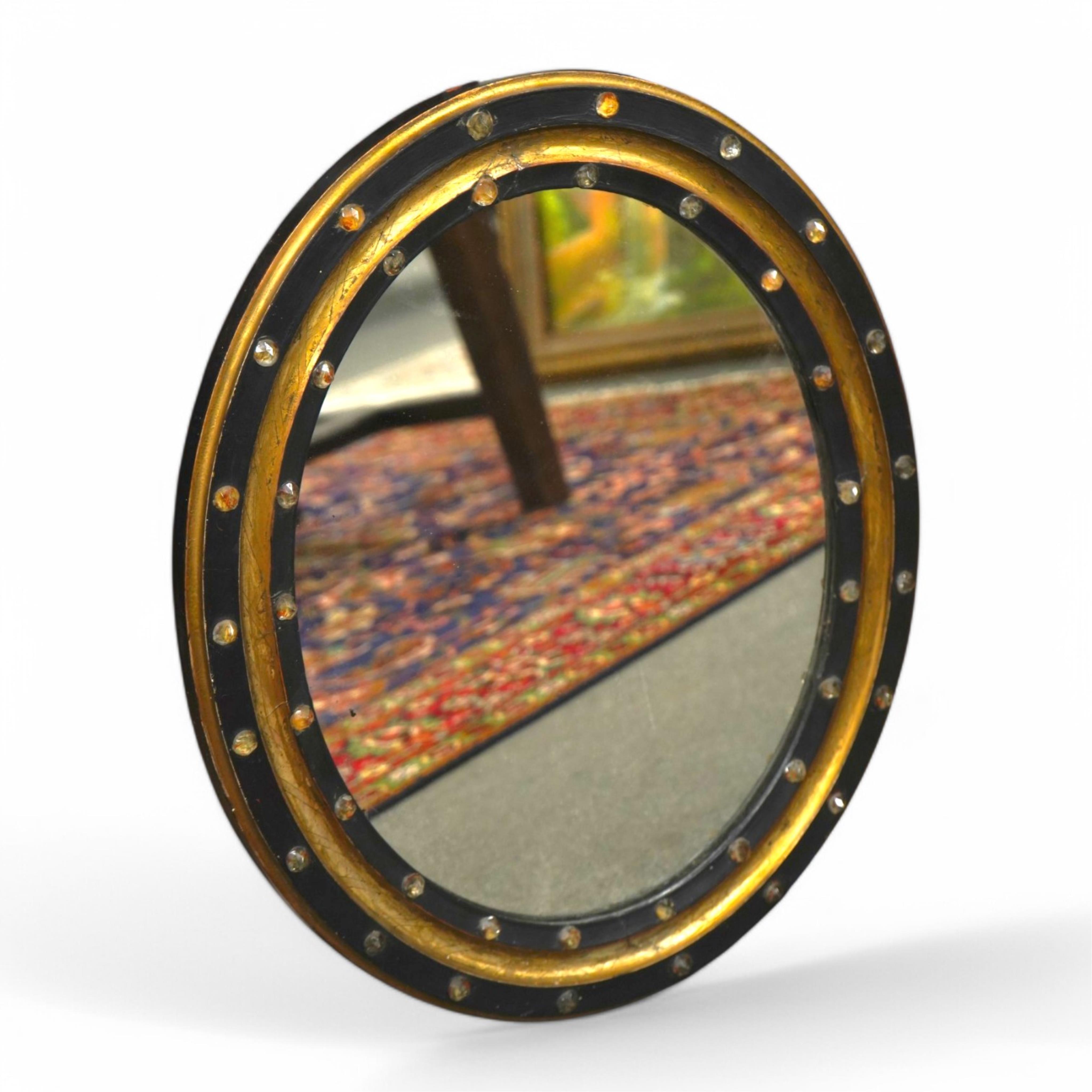 A 19th century oval Irish wall mirror, width 54cm, height 62cm. Condition - fair